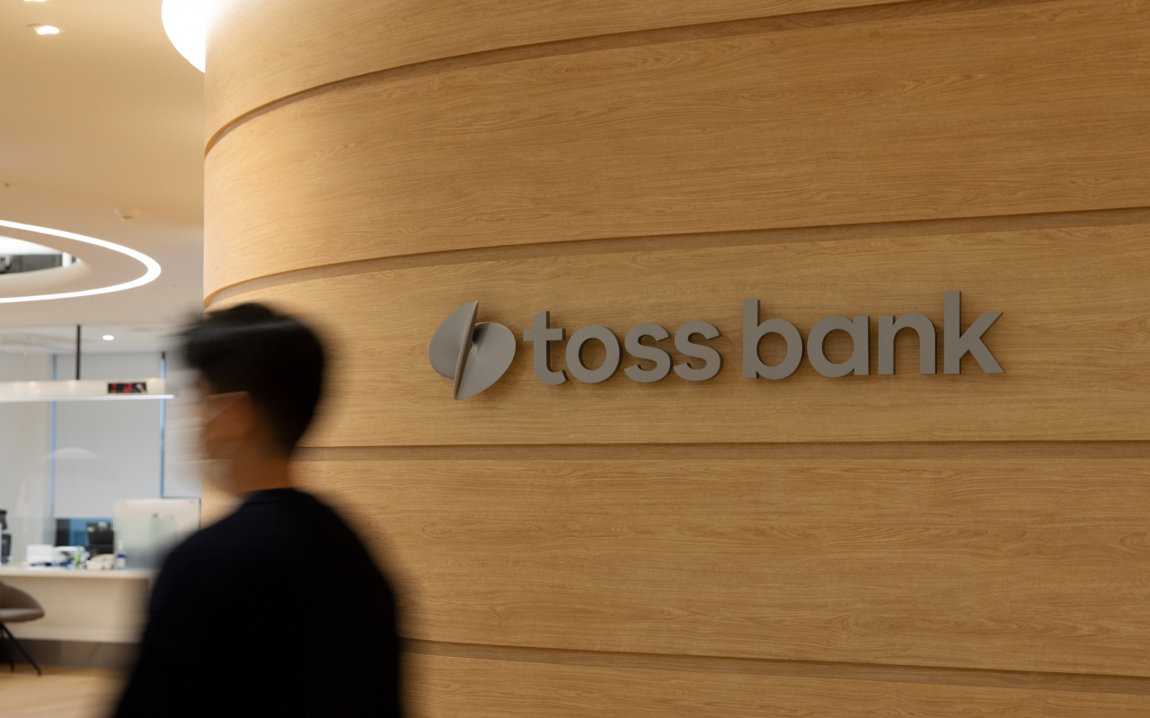 A person walks past a wall displaying Toss Bank's logo in the company's headquarters in Gangnam-gu, southern Seoul. (Toss Bank)