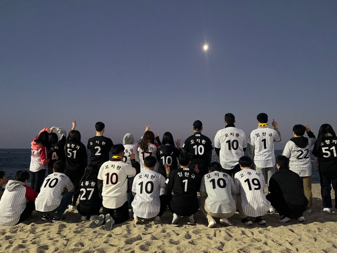 Live baseball game-watching club LG Eopsineun Motsara's members pose for a photo wearing their favorite players' uniforms in 2023. (Courtesy of Kim)