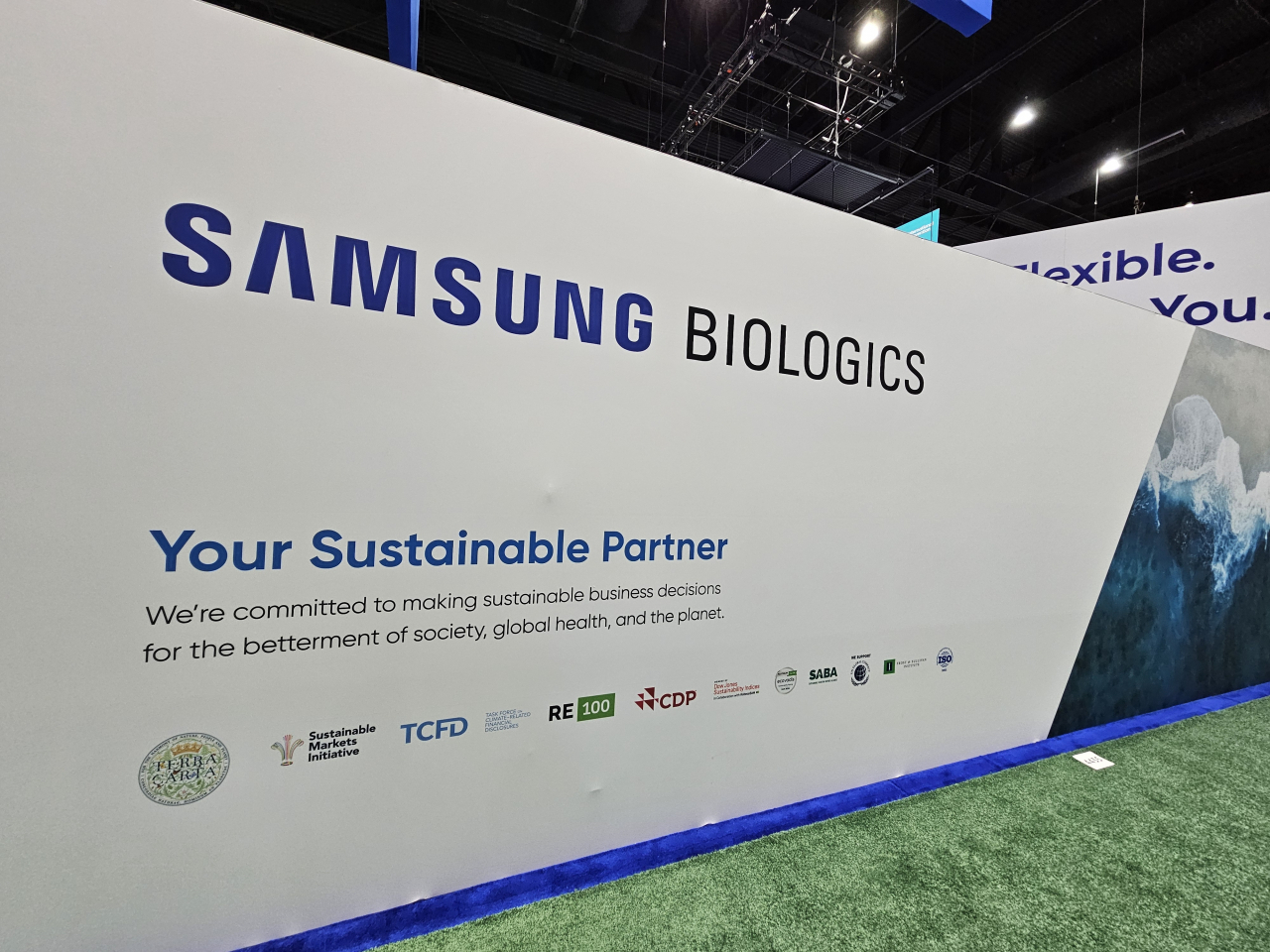 Samsung Biologics' booth wall highlights the company's achievements and partnerships with sustainable goals. (Kim Hae-yeon/ The Korea Herald)