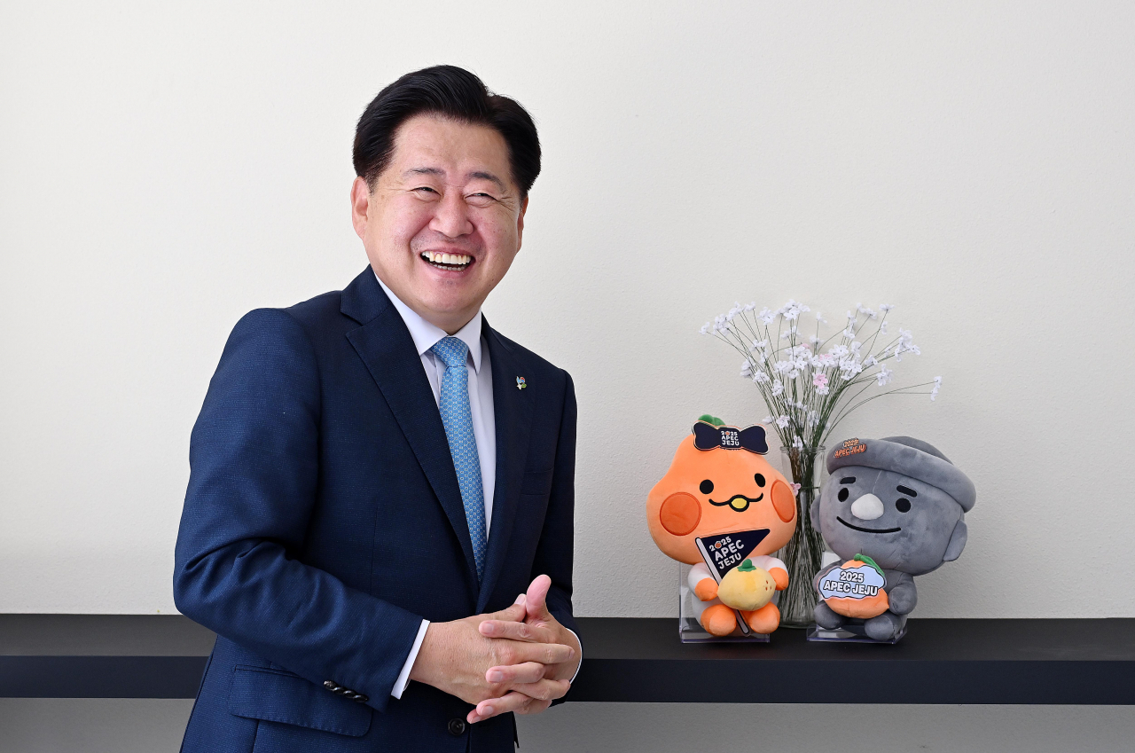 Oh Young-hoon, governor of Jeju Special Self-governing Province, poses with the island's mascots ahead of an interview with The Korea Herald in western Seoul on Tuesday. (Lee Sang-sub/The Korea Herald)