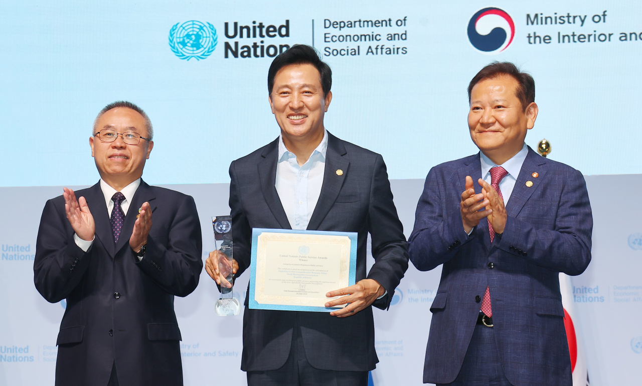Seoul Mayor Oh Se-hoon (center) poses for a photo with UN Under Secretary-General for Economic and Social Affairs Li Junhua (left) and Interior Minister Lee Sang-min after receiving a UN Public Service Award at the UN Public Service Forum held in Songdo, Incheon, Wednesday. (Yonhap)