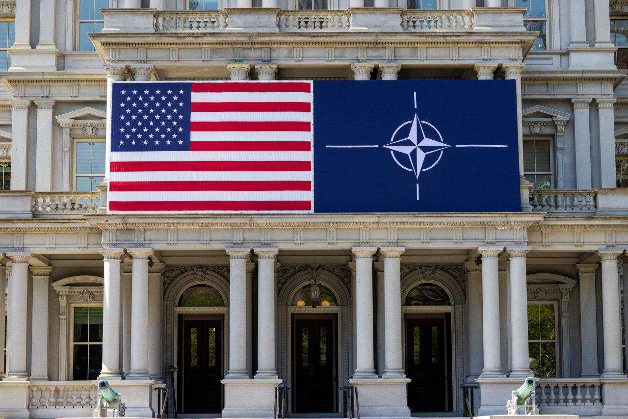 A view of the US flag alongside the NATO flag outside the Eisenhower Executive Office Building in Washington, US, Monday. (Reuters-Yonhap)