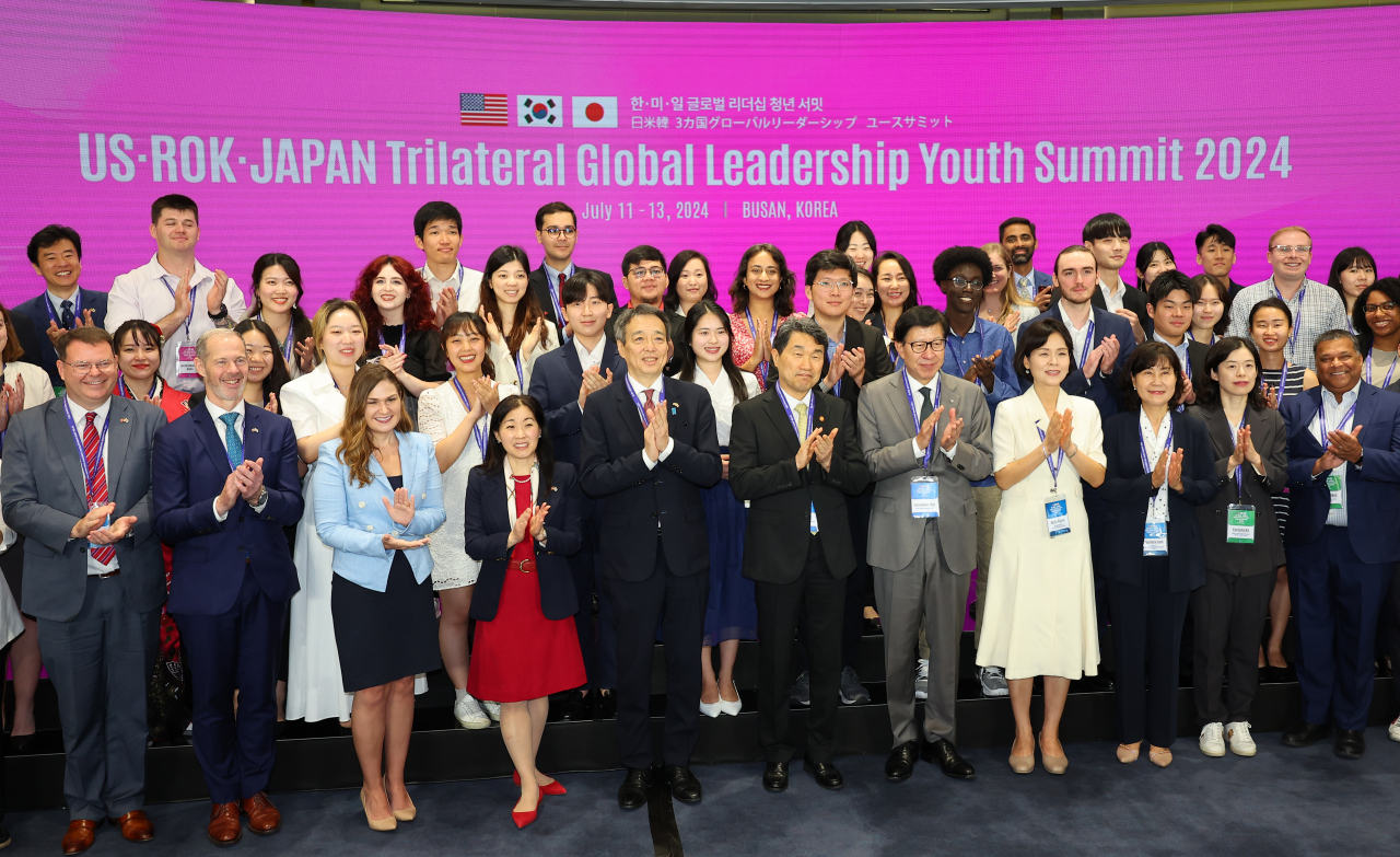 Deputy Prime Minister and Minister of Education Lee Ju-ho (sixth from left, front row) takes a photo with participants during the opening ceremony of the US-ROK-Japan Global Leadership Youth Summit at APEC House in Nurimaru, Haeundae-gu, Busan, on Thursday. (Yonhap)