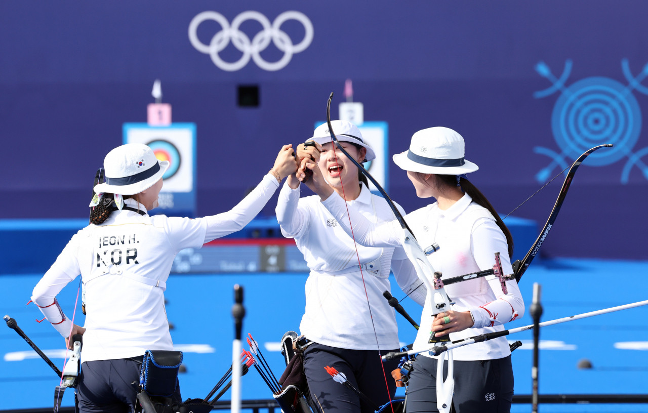 The South Korean women's archery team cheers after winning the gold medal in the women's team event Sunday at the Paris Olympics. (Yonhap)