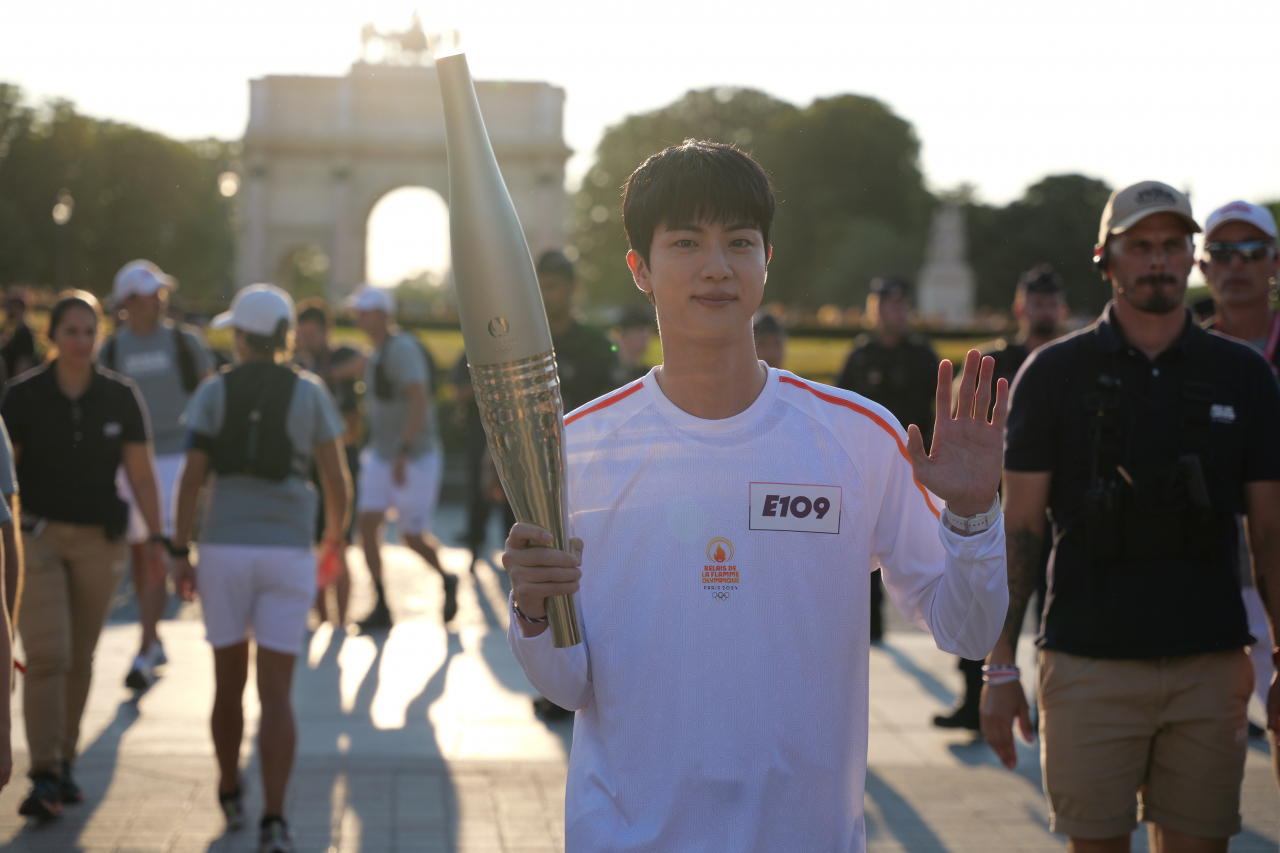 Jin of K-pop sensation BTS is greeted by cheering fans while carrying the torch for the 2024 Paris Summer Olympics on July 15. (Photo courtesy of the Paris Olympics organizing committee)