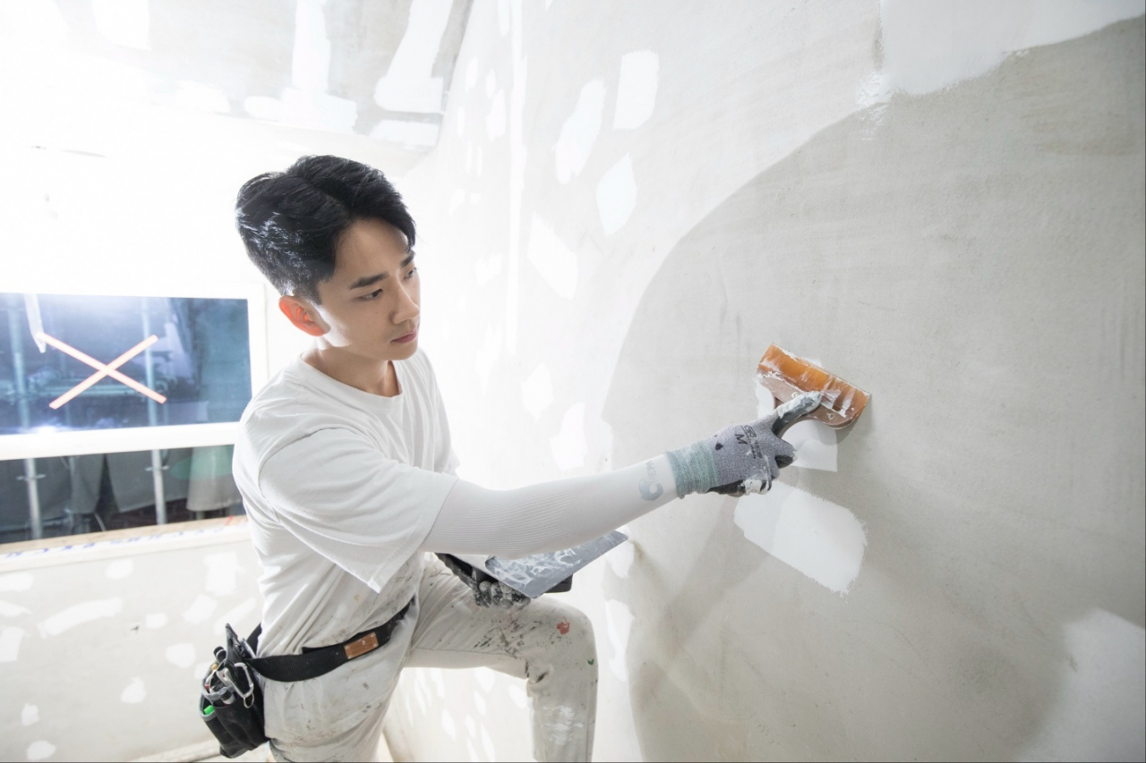 Oh Ji-min paints the walls of a client's office. (Kim Beom-ki)