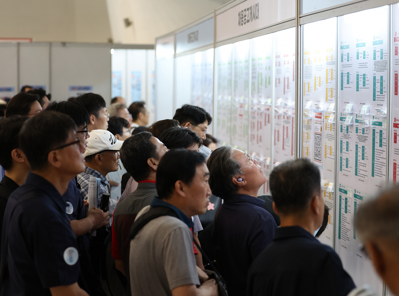 Jobseekers check job postings at a job fair at Dongdaemun Design Plaza in Seoul, in this file photo taken July 22.