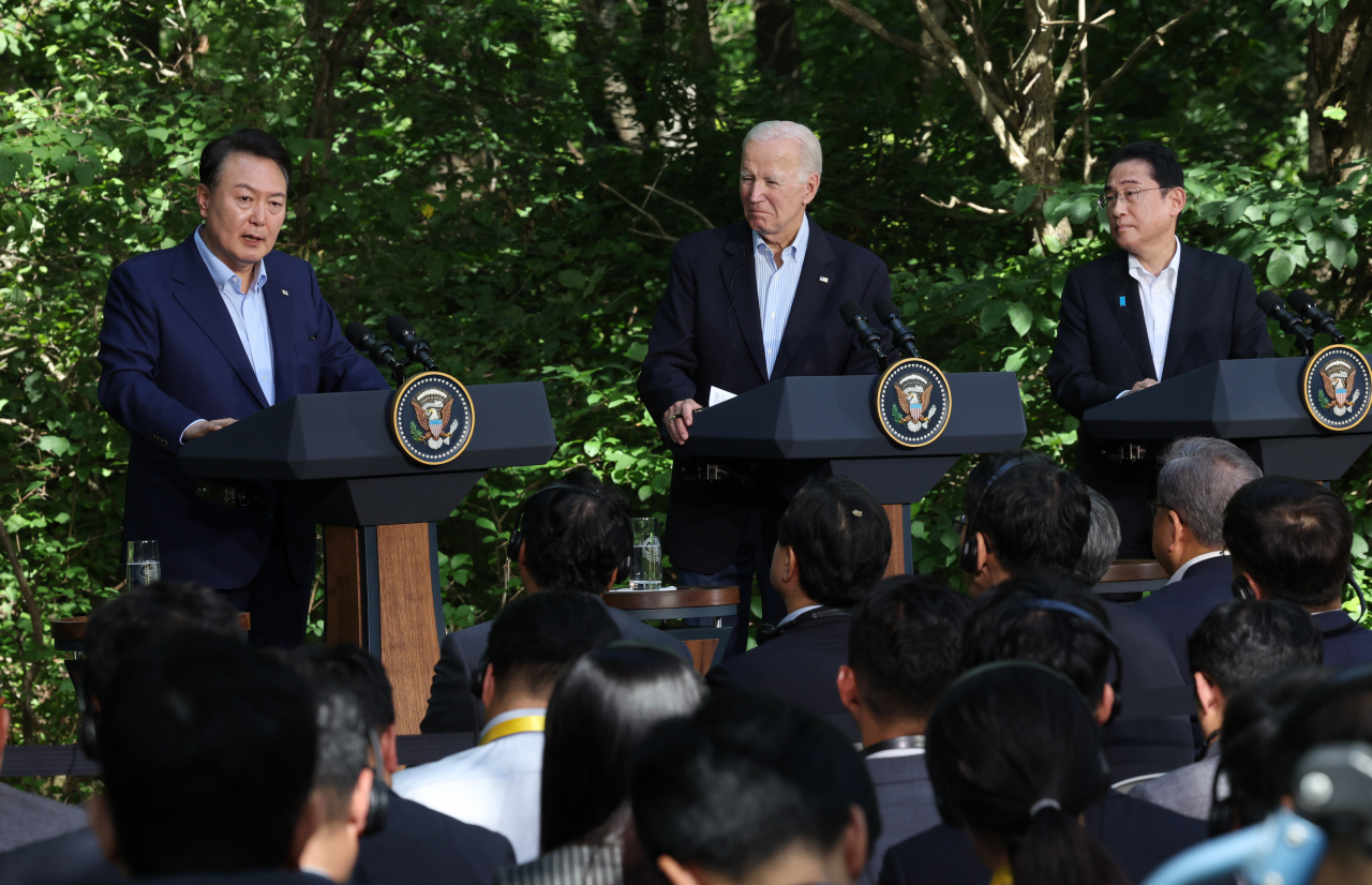 This file photo from August 18, 2023, shows South Korean President Yoon Suk Yeol, US President Joe Biden, and Japanese Prime Minister Fumio Kishida holding a joint press conference following a trilateral summit at the Camp David presidential retreat in Maryland. (Yonhap)