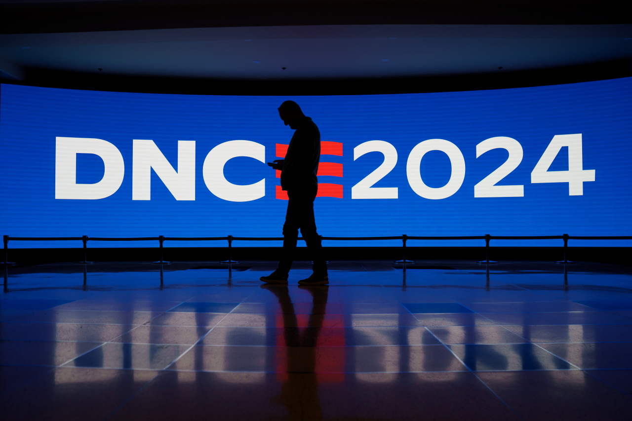 A member of staff passes a digital display at the United Center ahead of the Democratic National Convention in Chicago, Illinois, Saturday.