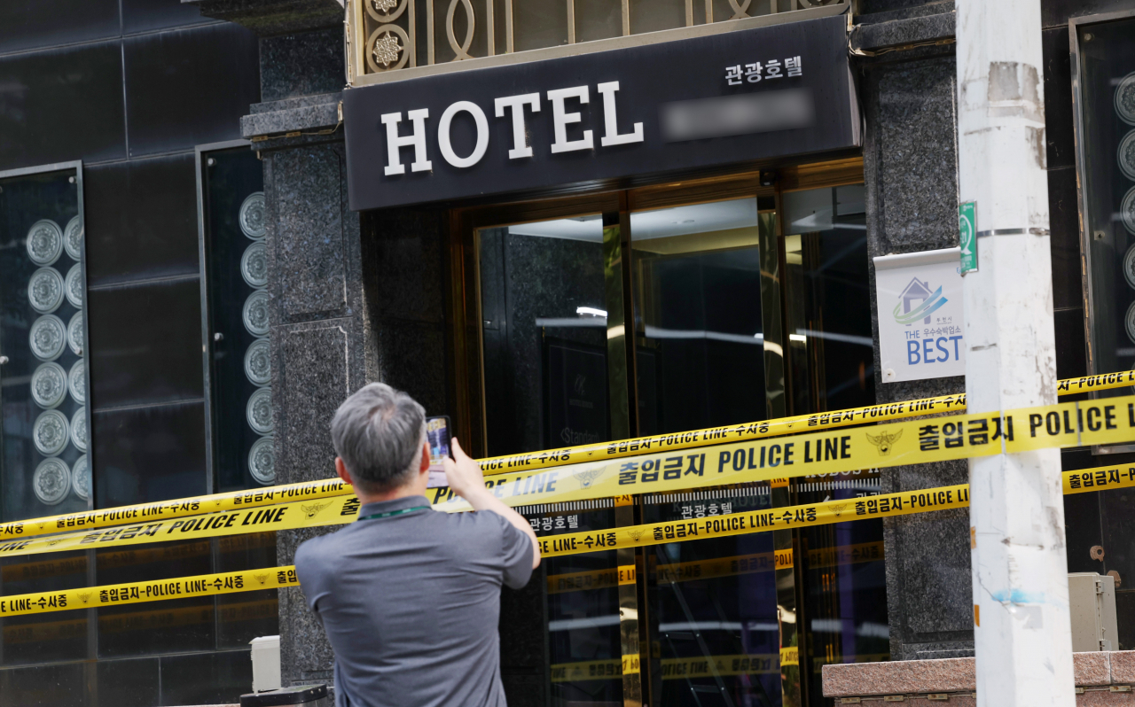 A man stands in front of a hotel in Bucheon, Gyeonggi Province, where a deadly fire broke out on Thursday that left seven dead and a dozen others injured on Saturday. (Yonhap)