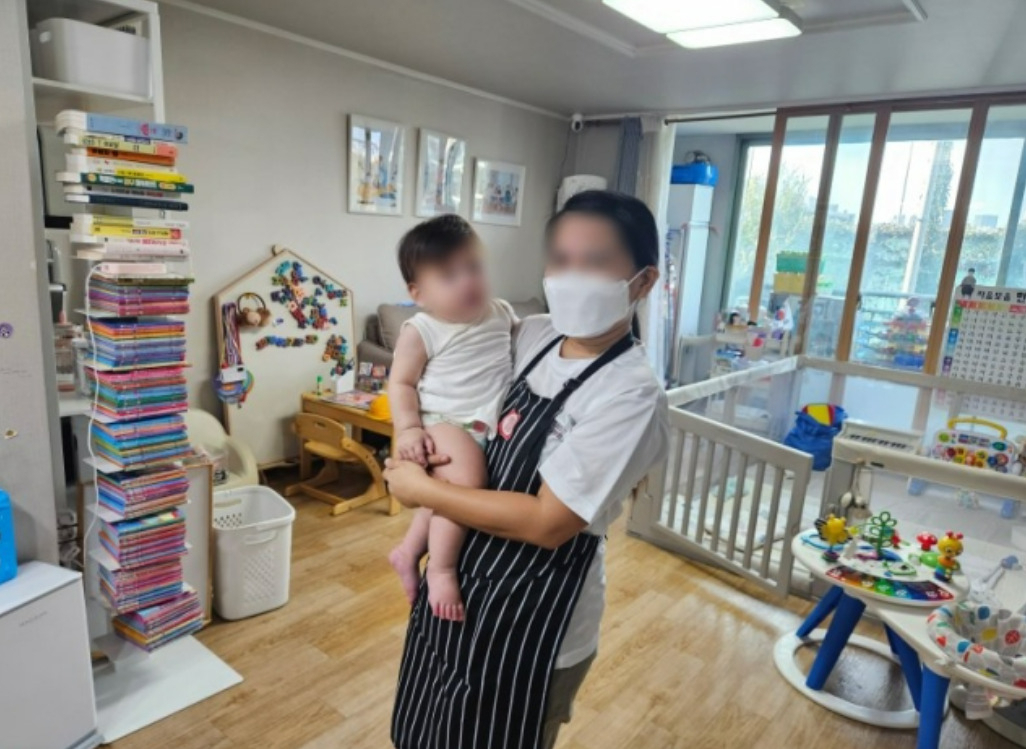 A Filipina domestic helper takes care of a baby in a home in Seoul. (The Seoul Metropolitan Government)