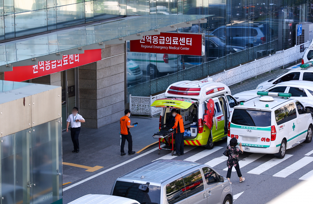 Emergency rescue workers and ambulances are seen outside the emergency medical center at a university hospital in Seoul on Tuesday. (Yonhap)