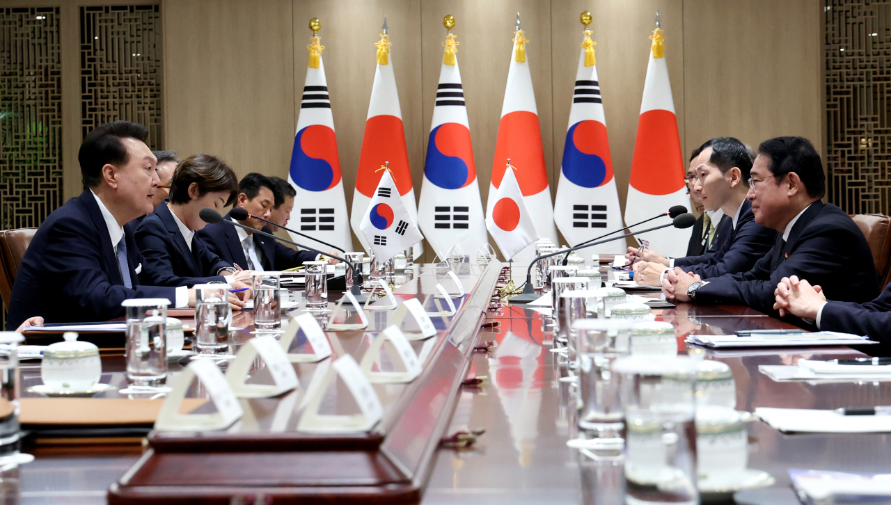 South Korean President Yoon Suk Yeol talks with Japanese Prime Minister Fumio Kishida during their talks at the presidential office in Seoul on Friday. (Pool photo via Yonhap)