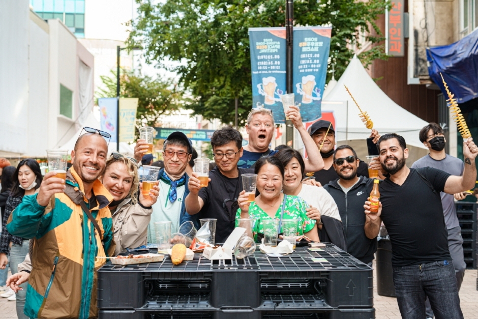 Visitors to the Myeongdong Beer Festival pose for photos on the street in Myeong-dong, central Seoul. (Korea Tourism Organization)