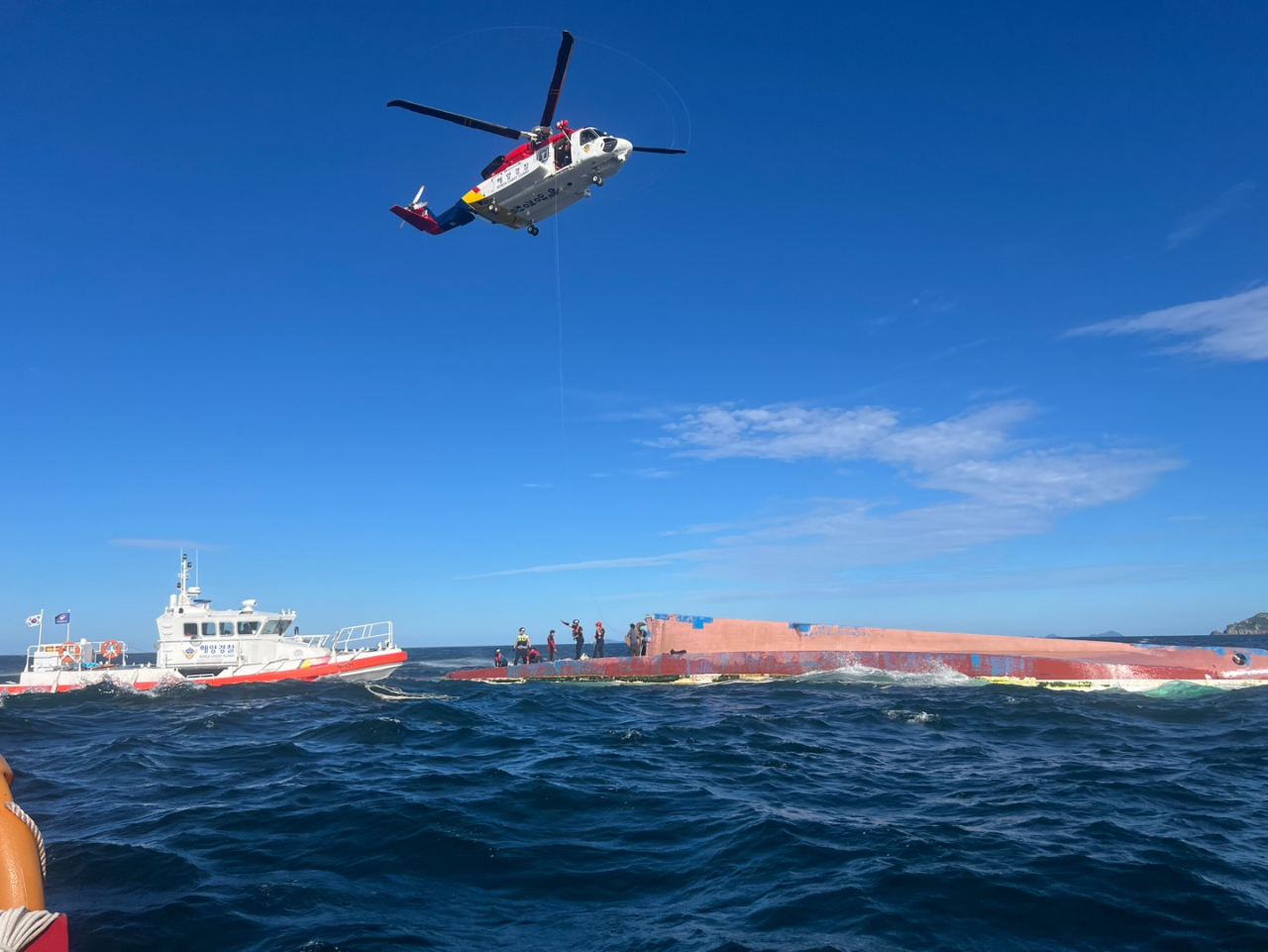 A 35-ton fishing vessel capsizes in waters near Gunsan, a southwestern port city in North Jeolla Province, in this photo provided by the Korea Coast Guard on Monday. (Yonhap)