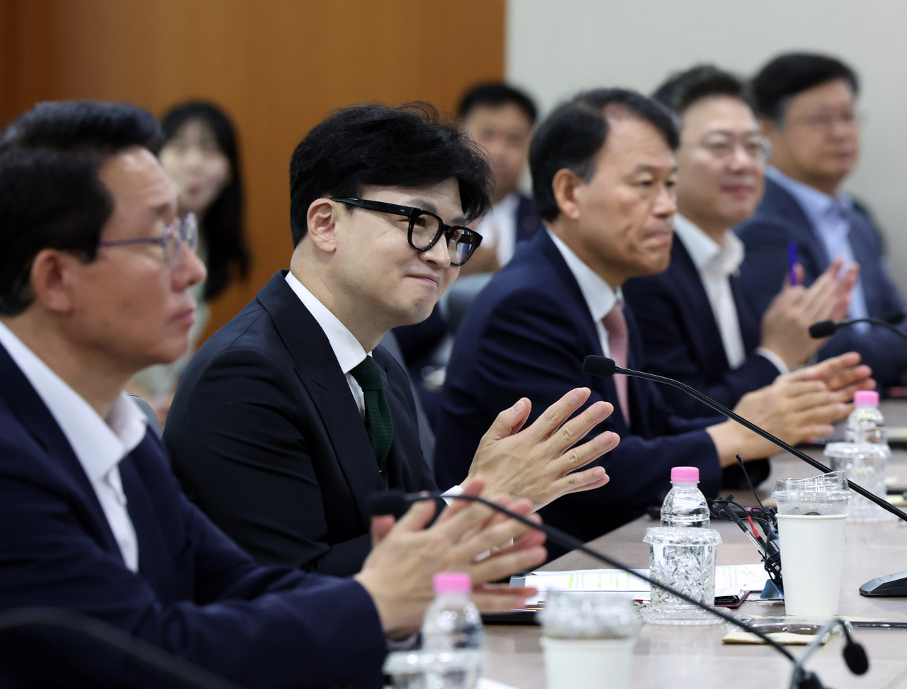 Han Dong-hoon (second from left), leader of the ruling People Power Party, participates in a meeting with officials from the financial industry to talk on the abolition of a capital gains tax imposed on financial investments held at the headquarters of Korea Exchange in Seoul. (Yonhap)