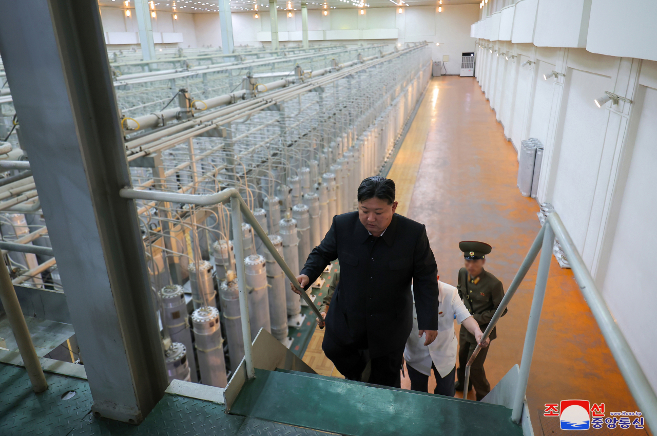 In this undated photo released on Sept. 13, North Korean leader Kim Jong-un (front) is seen inspecting an uranium enrichment facility. (KCNA-Yonhap)