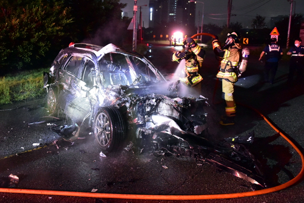 Firefighters extinguish a vehicle fire from a fatal car accident that resulted in the driver's death, in Gwangju, Sunday. (Gwangju Gwangsan Police Station)