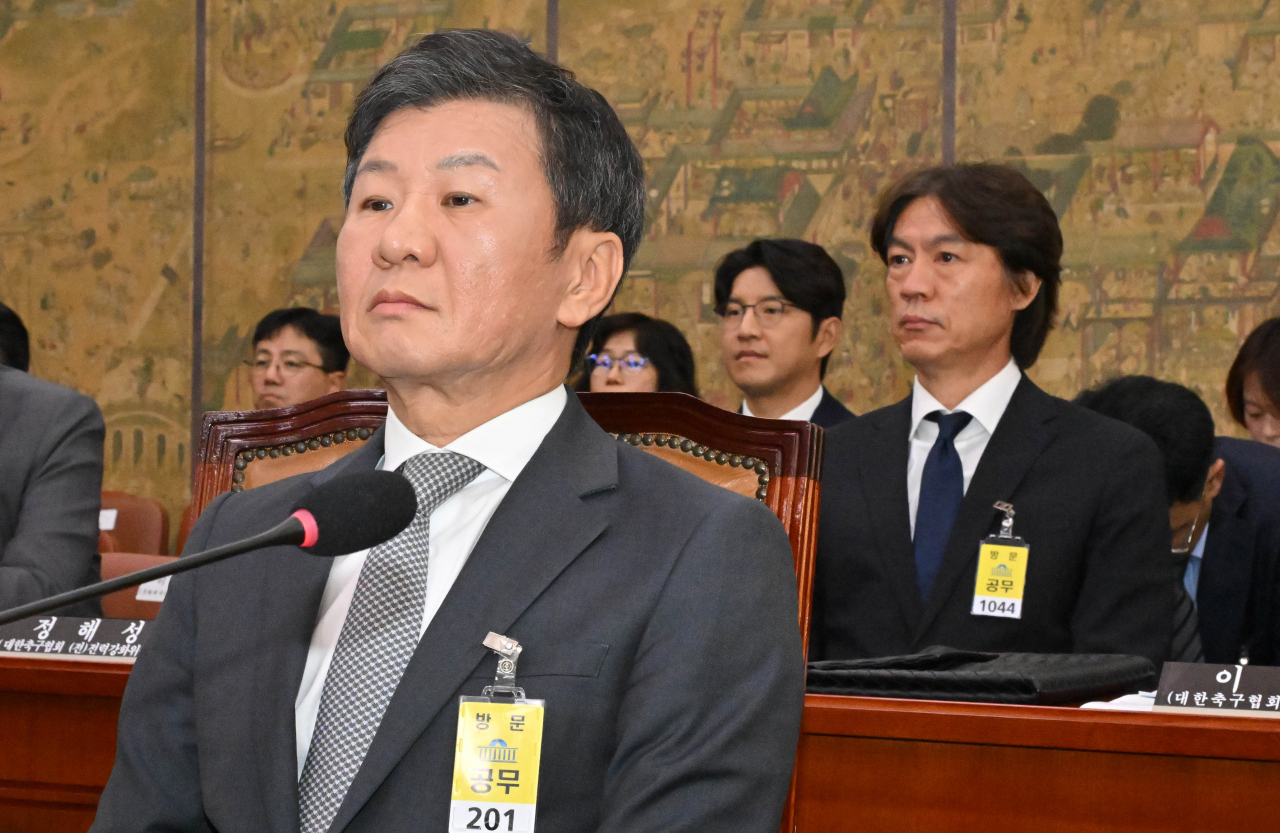 Chung Mong-gyu, head of the Korea Football Association, front, and men’s national football team head coach Hong Myung-bo attend a parliamentary hearing at the National Assembly in Seoul on Tuesday. (Yonhap)