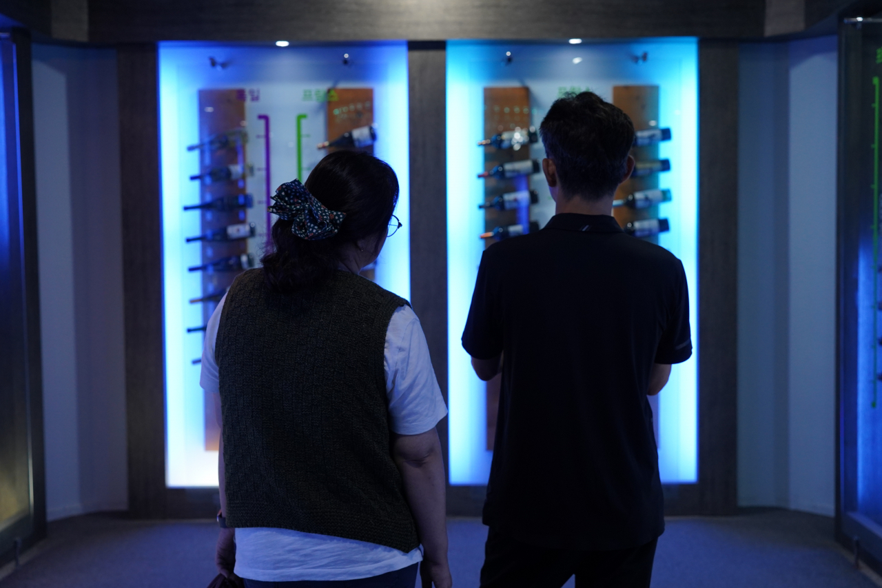 Visitors view wines on display at Yeongdong Wine Tunnel in Yeongdong, North Chungcheong Province on Sept. 20. (Lee Si-jin/The Korea Herald)