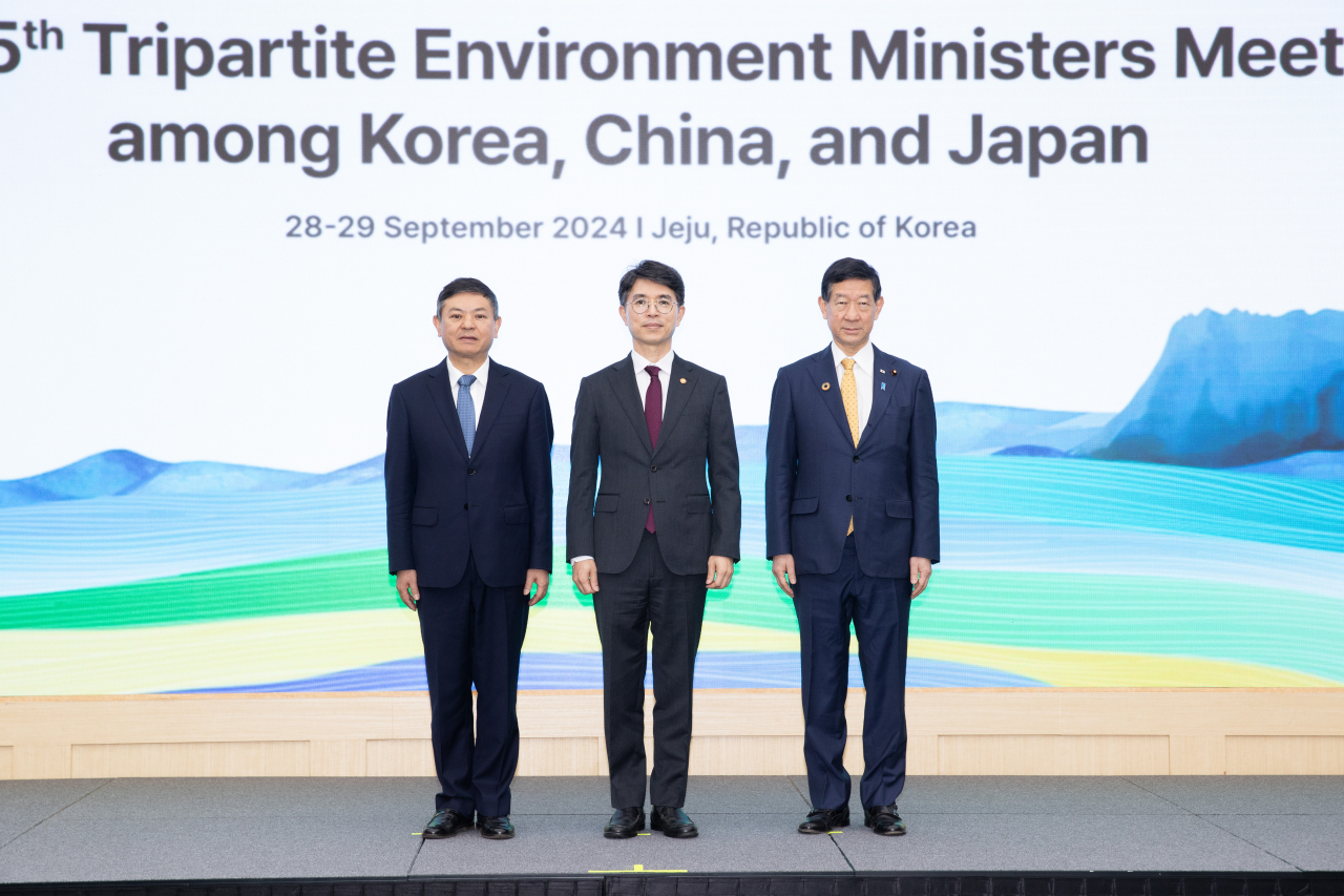 Korean Environment Minister Kim Wan-seop (center) poses with his Chinese counterpart Huang Runqiu (left) and Japanese counterpart Shintaro Ito during a trilateral meeting in the International Convention Center on Jeju Island, Sunday. (Environment Ministry)