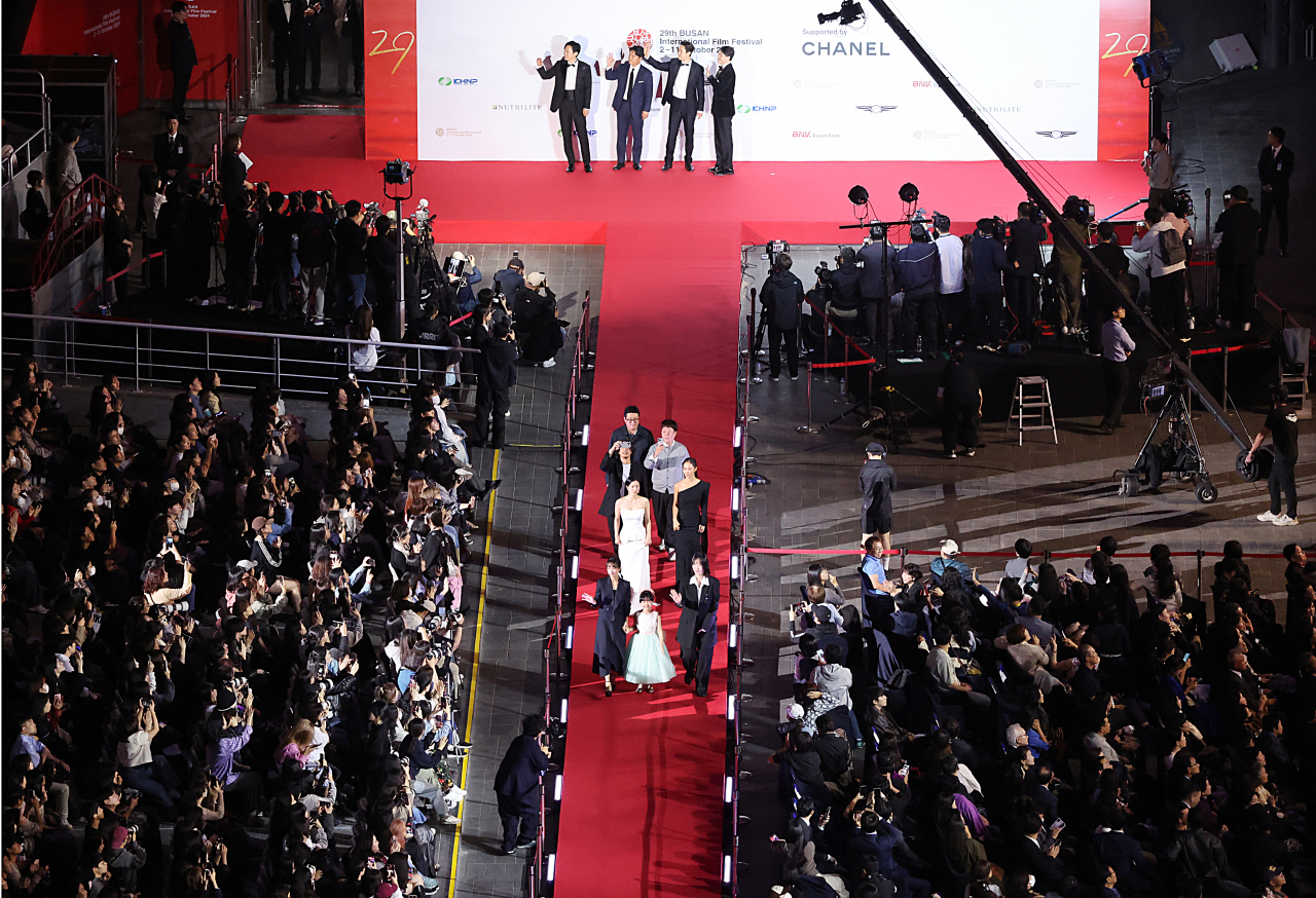 Actors attend the red carpet event during the opening ceremony of the 29th Busan International Film Festival on Wednesday. (Yonhap)