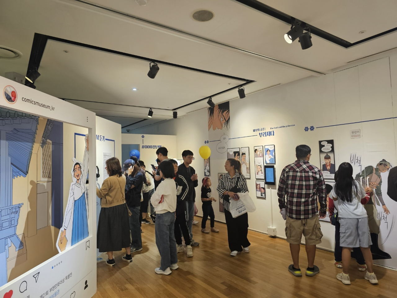 Visitors view an exhibition of Naver Webtoon 