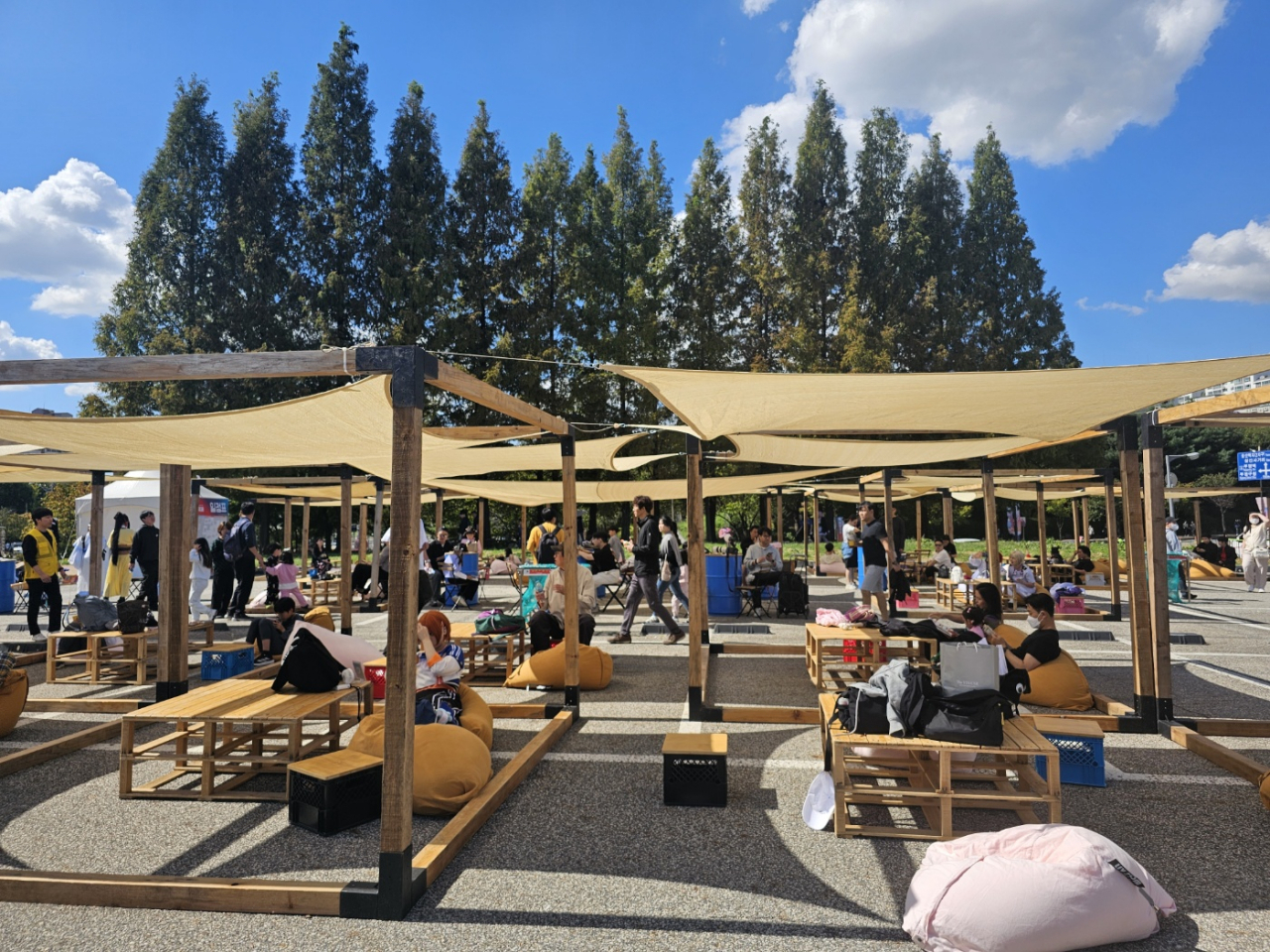 Visitors are seen reading cartoons in the outdoor cartoon reading space located at the 2024 BICOF held in Bucheon, Gyeonggi Province. (Lee Yoon-seo/The Korea Herald)