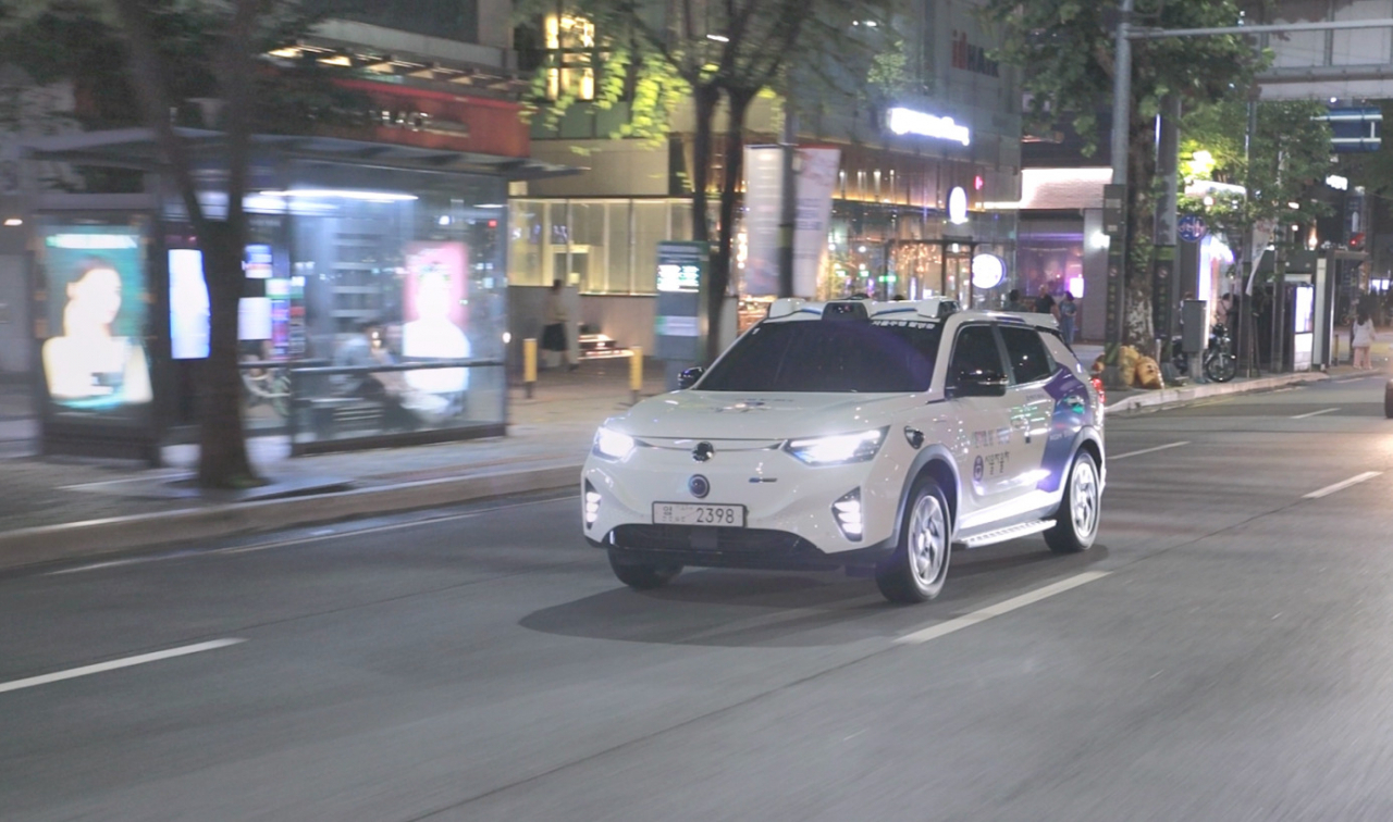 KG Mobility's Korando E-Motion, specifically developed for Seoul's trial of nighttime autonomous driving taxi services, drives down the street in Gangnam-gu. (KG Mobility)