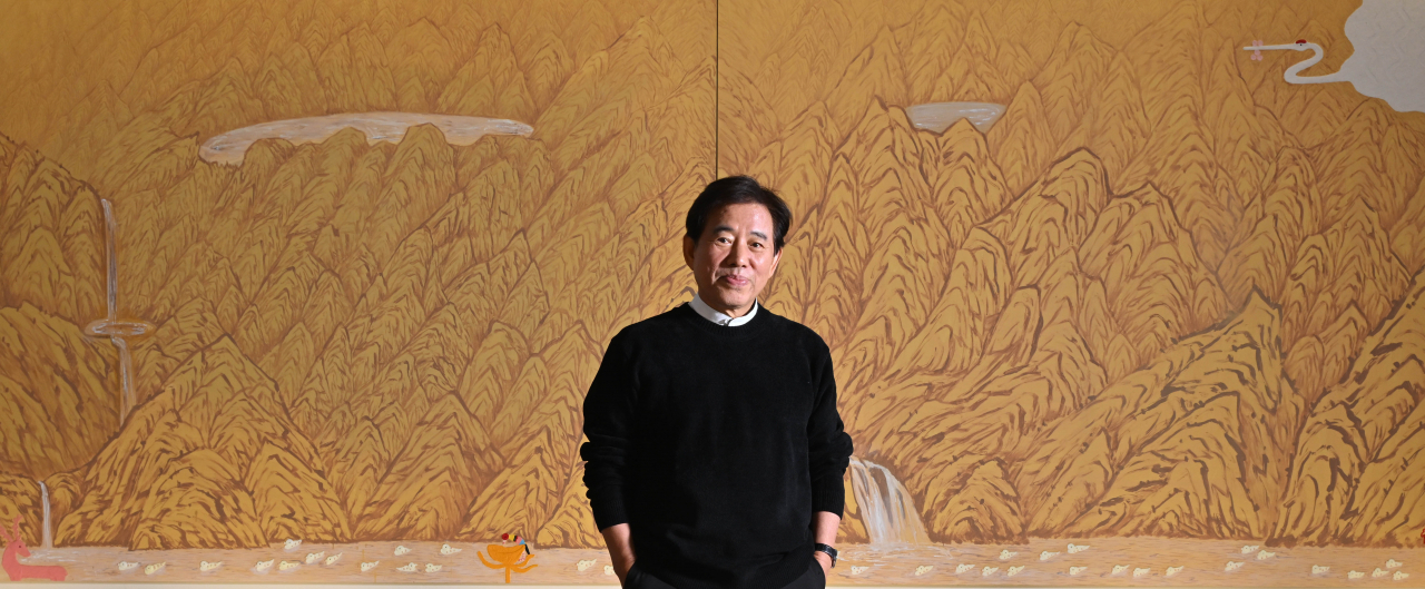 Kim Byung-jong poses for a photo at the exhibition “The Rhapsody of Life: A Half-Century Art Archive of Kim Byung-jong” on Friday at Culture Station Seoul 284 in Seoul. (Im Se-jun/The Korea Herald)