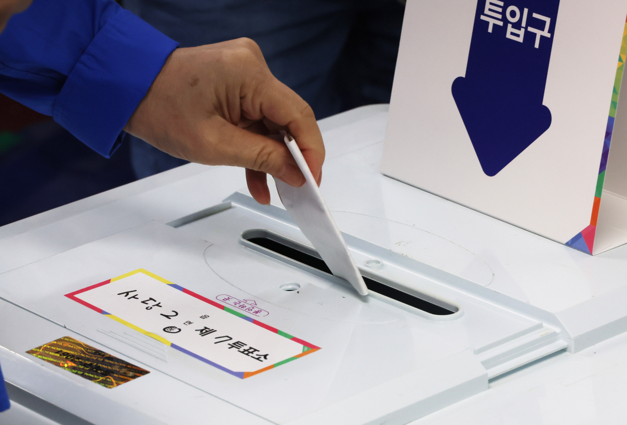 A voter casts a ballot during a by-election for an administrative seat at a ballot station in Sadang 2-dong, Dongjak-gu, Seoul, on Wednesday.