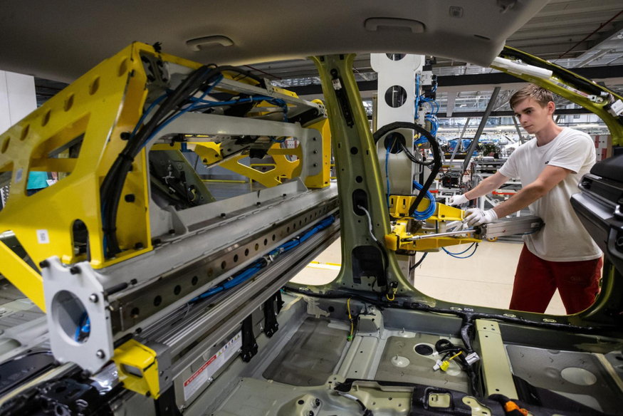 A Kia employee works on a car assembly line at the company’s auto manufacturing plant in Zilina, northwestern Slovakia. (Kia)