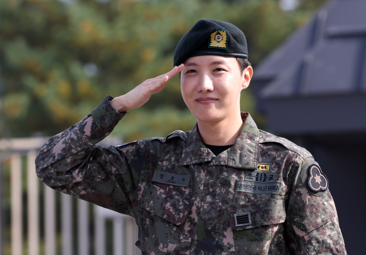 J-Hope of BTS salutes fans and media after being discharged from military service at the 36th Recruit Training Battalion in Wonju, Gangwon Province, Thursday. (Yonhap)