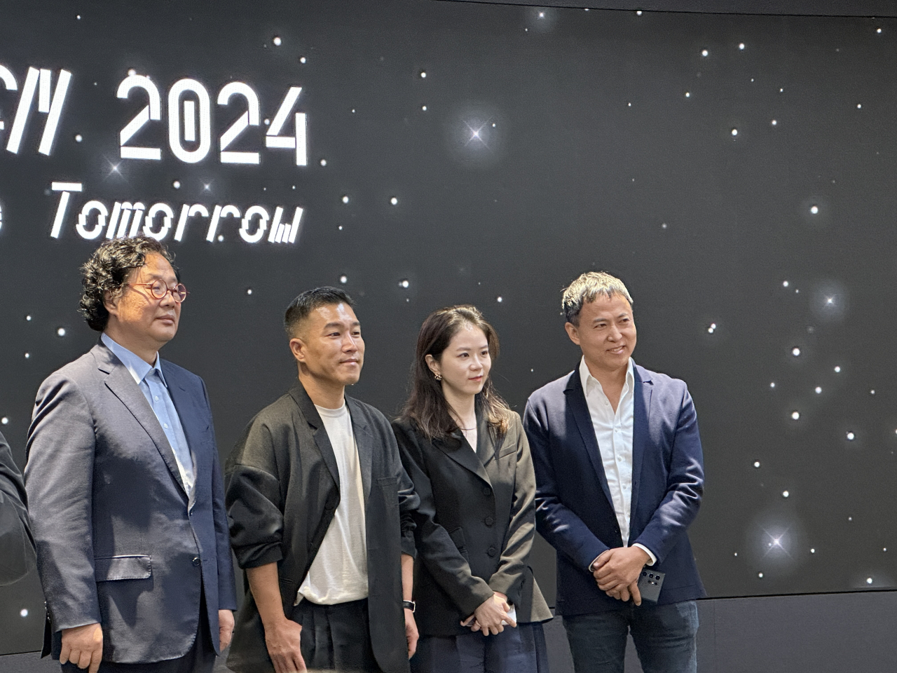 From left: Cha Kang-heui, CEO of Seoul Design Foundation, Kim Jong-wan, CEO of Jongkim Design Studio, media art designer Kang Yi-yun and Lee Dae-hyung, curator of Seoul Design 2024 pose for a photo during a press conference on Thursday at Dongdaemun Design Plaza in Jung-gu, central Seoul. (Lee Jung-joo/The Korea Herald)