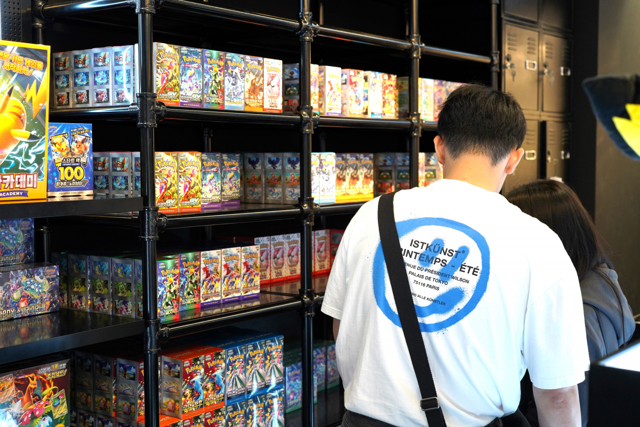 A couple looks at Pokemon cards at Pokemon Card Shop in HDC IPark Mall in Yongsan, central Seoul. (Lee Si-jin/The Korea Herald)