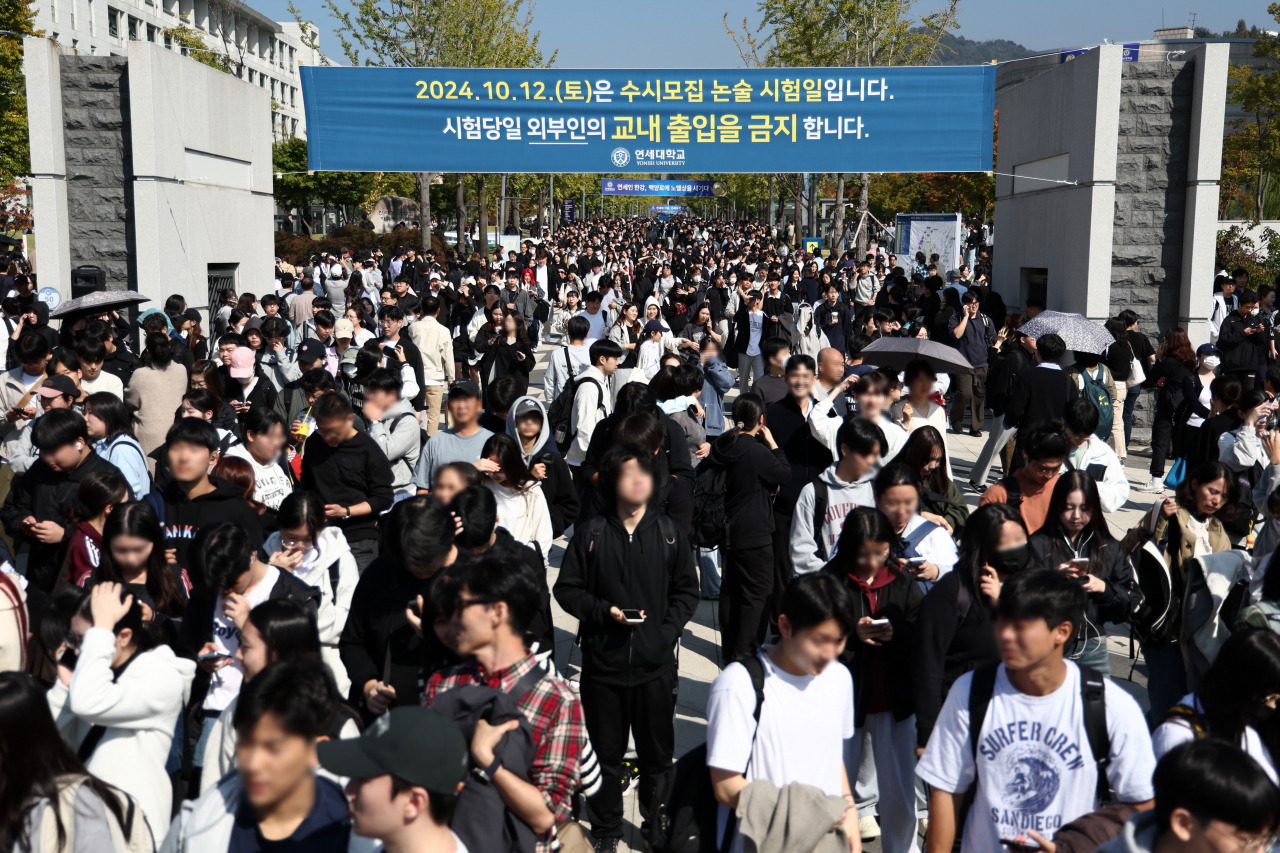 Students leave the testing site after taking the college entrance exam test for Yonsei University's 2025 school year on Oct. 12. (Yonhap)