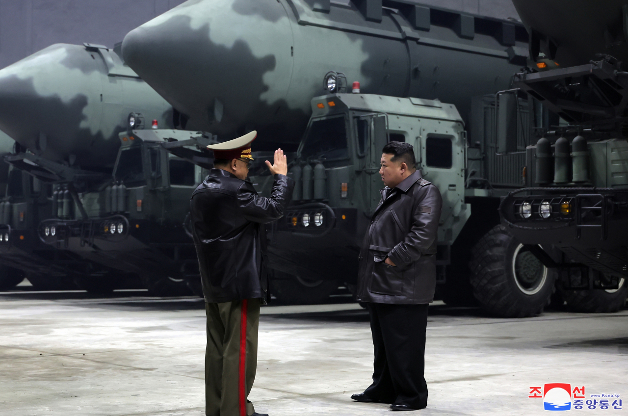 North Korean leader Kim Jong-un (right) inspects a strategic missile base with a Hwasong-18 intercontinental ballistic missile mounted on a mobile launcher behind him, as shown in a photo released by the state-run Korean Central News Agency on Wednesday. (Yonhap)