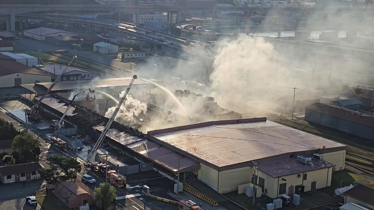 Firefighters nearly put out a fire at a US Forces Korea warehouse in the southeastern port city of Busan on Thursday. (Yonhap)