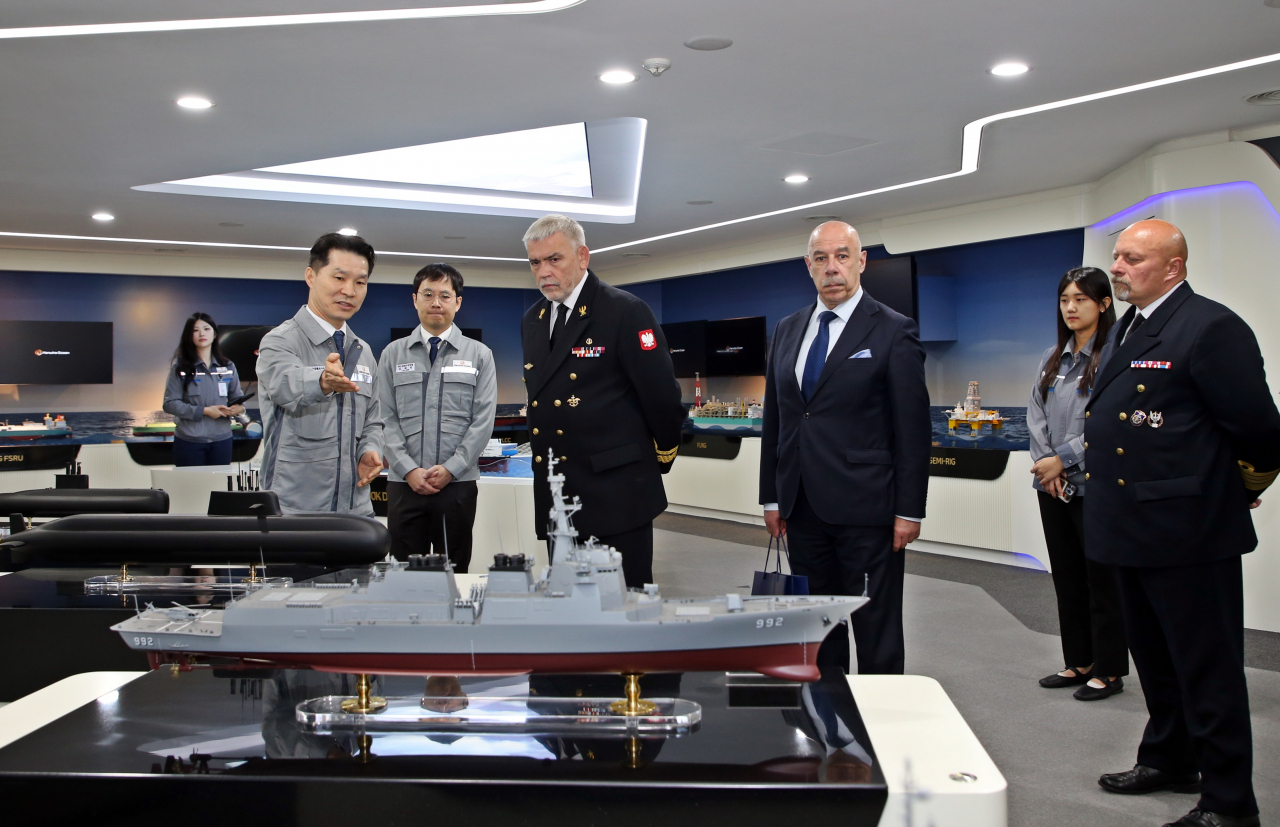 Hanwha Ocean officials brief Tomasz Szubrycht (third from left), commandant of the Polish Naval Academy, on its shipbuilding portfolio at the company’s Geoje shipyard in South Gyeongsang Province, Wednesday. (Hanwha Ocean)