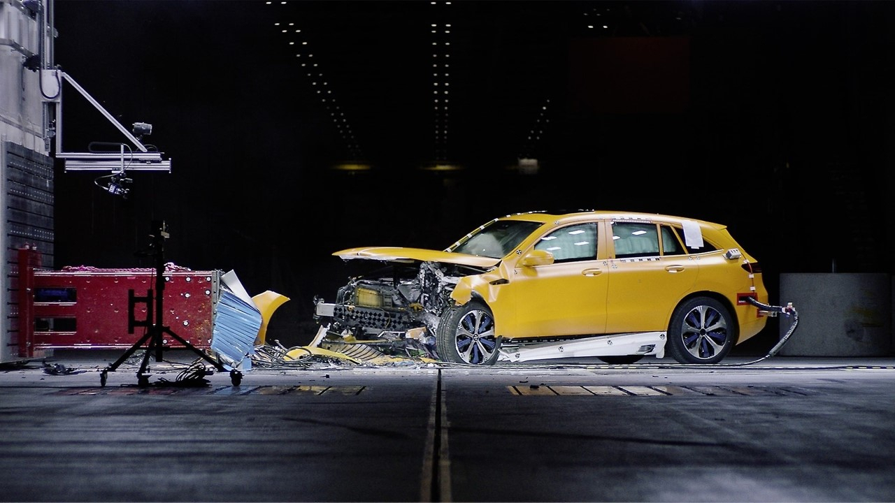 An all-electric Mercedes EQC sport utility vehicle is captured mid-crash during another test at Mercedes-Benz’s Sindelfingen crash lab, with its crumpled front end absorbing the impact against a 500-ton barrier. (Mercedes-Benz)