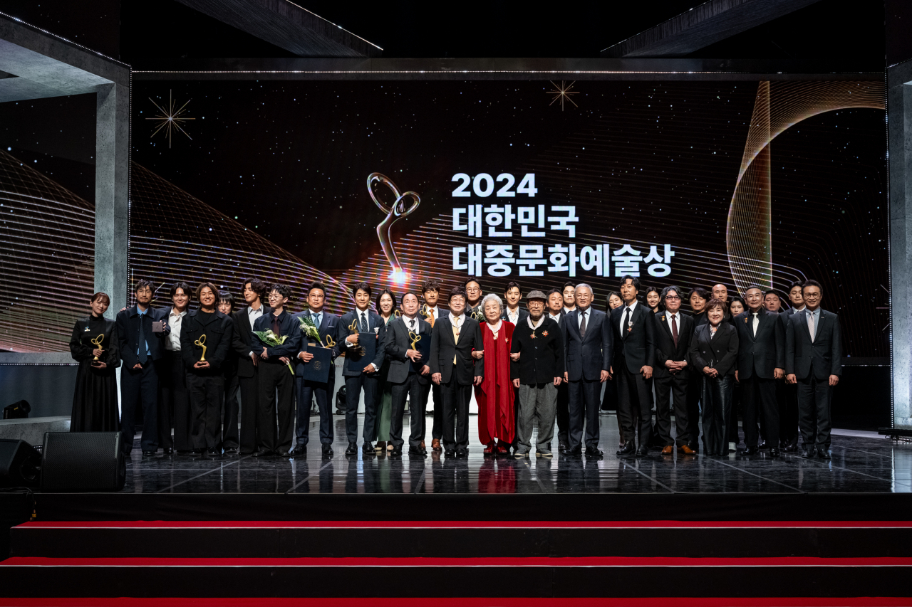 Recipients of the 2024 Korea Popular Culture and Arts Awards pose for photos at the awards ceremony held at the National Theater of Korea in Seoul on Thursday. (Korea Creative Content Agency)