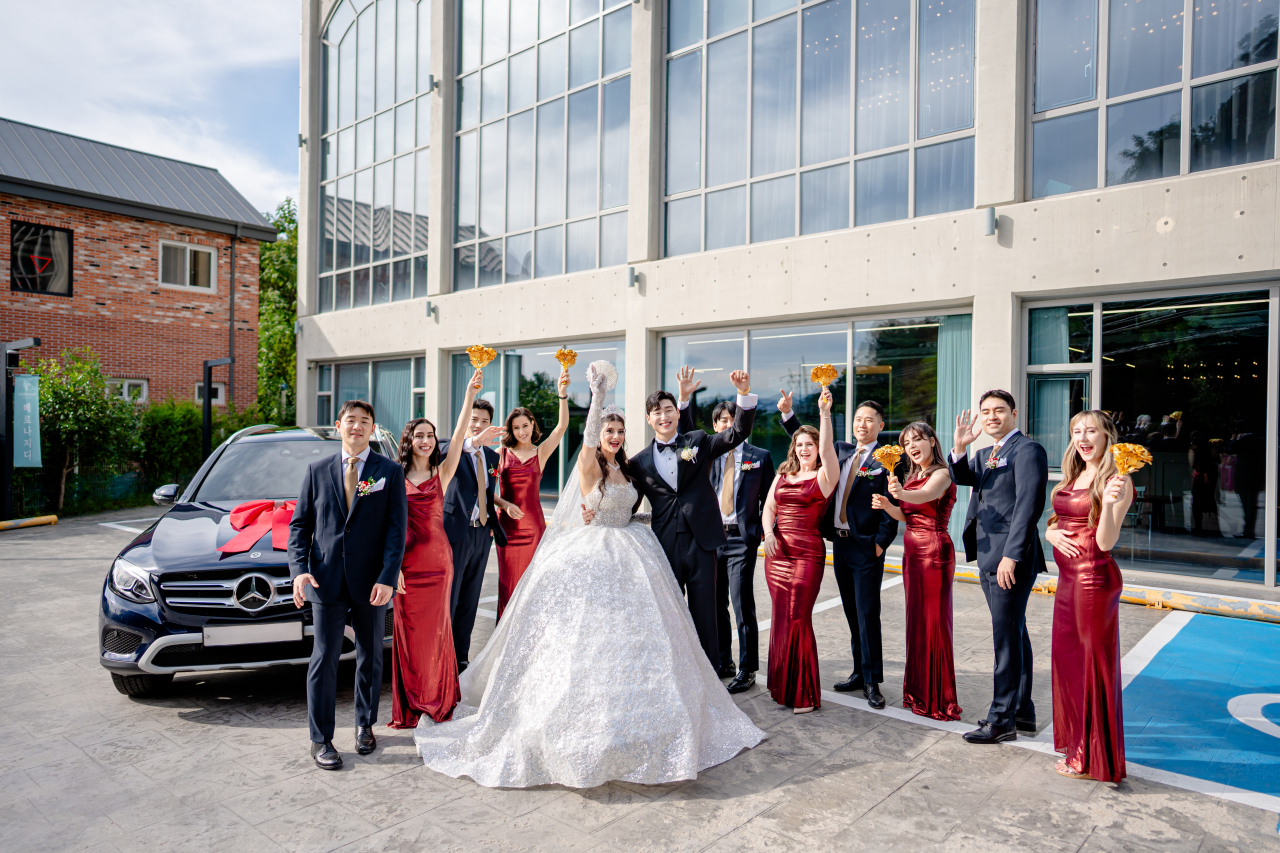 Rebecca Nour, a Lebanese American influencer, and her significant other, David Yang from South Korea (center), pose for a photo with their bridesmaids and groomsmen (Rebecca Nour)