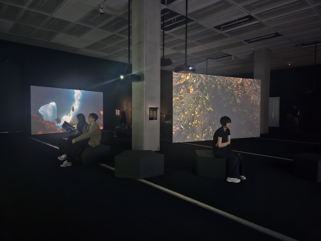 Visitors watch Jane Jin Kaisen's video works as part of Korea Artist Prize 2024 on Sunday at MMCA (Park Yuna/The Korea Herald)