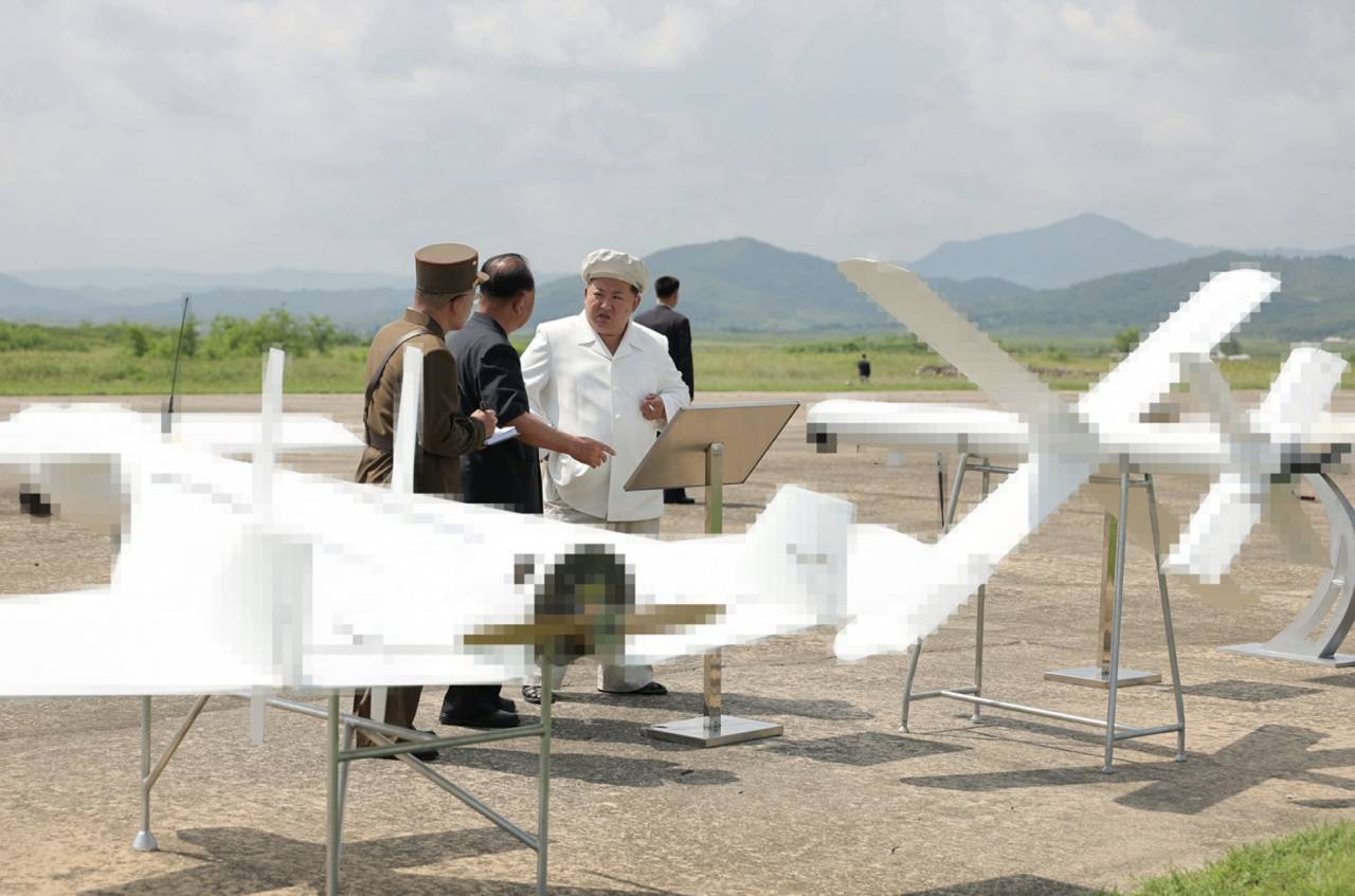 North Korean leader Kim Jong-un oversees a drone test in this photo published by the Korean Central News Agency on Aug. 26. (KCNA)