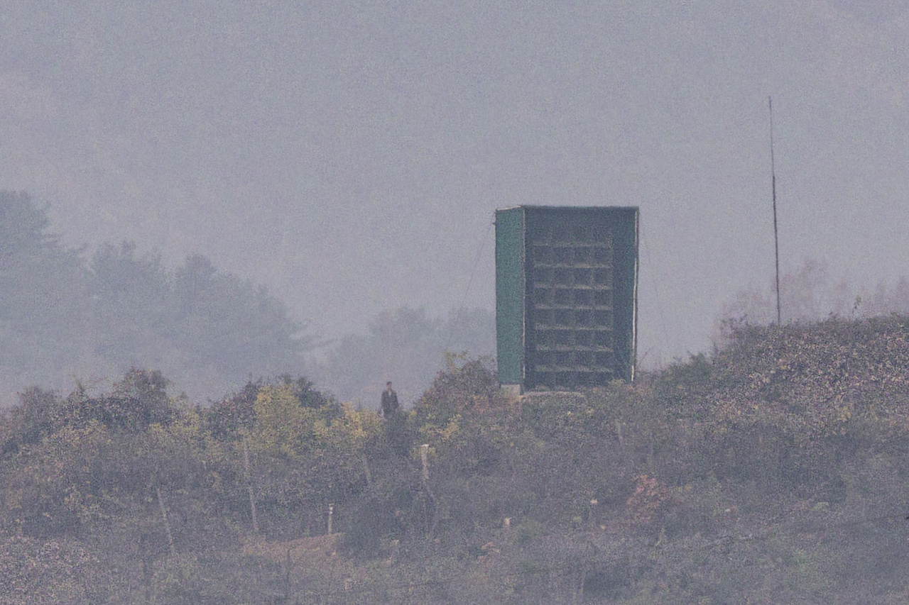 A North Korean soldier is seen next to a loudspeaker used to broadcast noise to South Korean border regions in the county of Gaepung, North Hwanghae Province, North Korea, on Friday. (Yonhap)