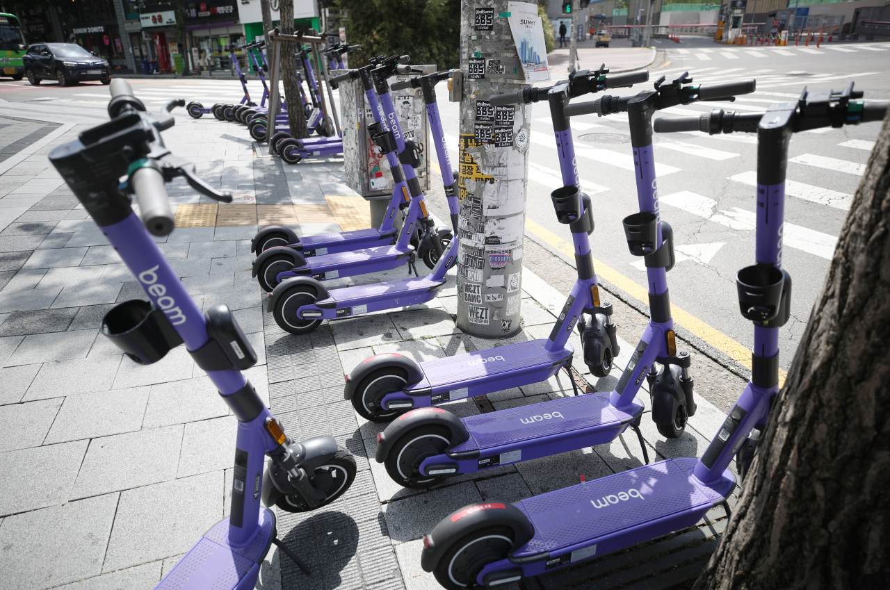 Electric kick scooters are parked along the sidewalk near Hongdae in Mapo-gu, western Seoul. (Korea Herald DB)