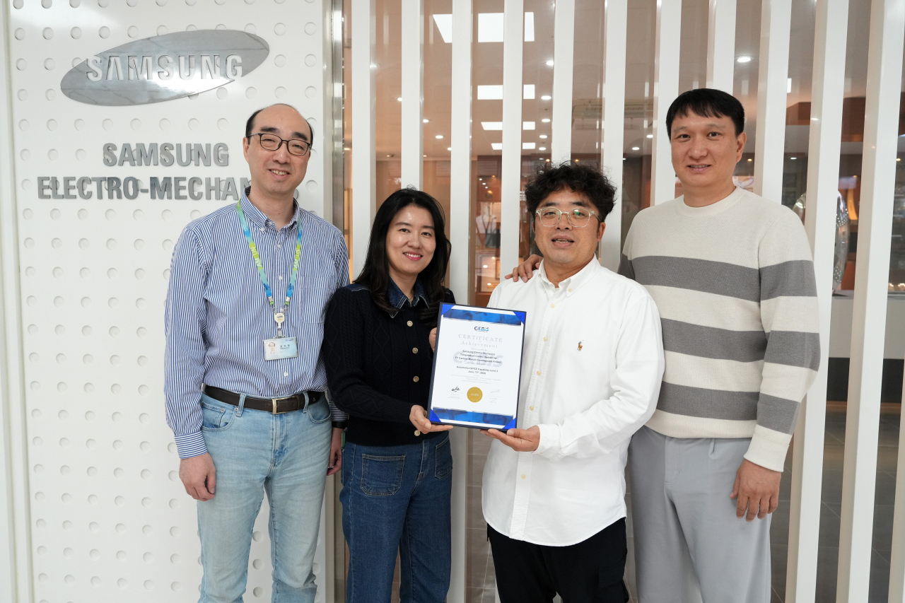 Samsung Electro-Mechanics employees pose for a photo with an A-spice level 3 certification. (Samsung Electro-Mechanics)