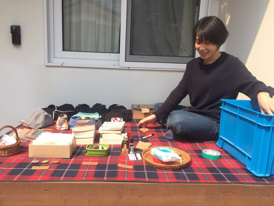 Park Hey-yoon sits next to the items that will go on sale at a flea market hosted at the 