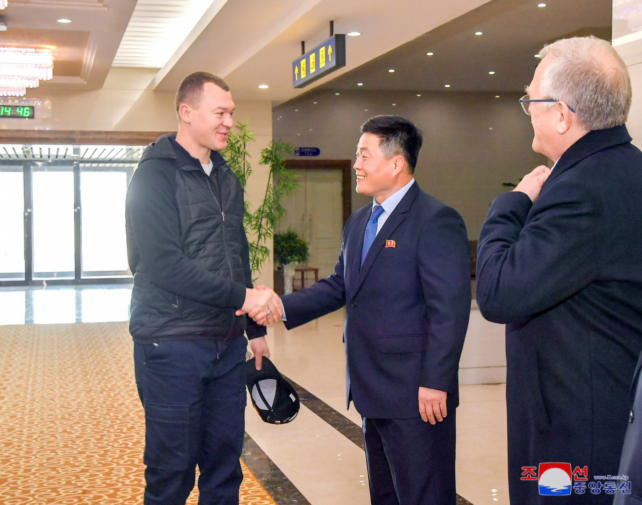 This photo, published by the Korean Central News Agency on Saturday, shows Russian Sports Minister Mikhail Degtyarev (left) arriving in Pyongyang the previous day. (Yonhap)