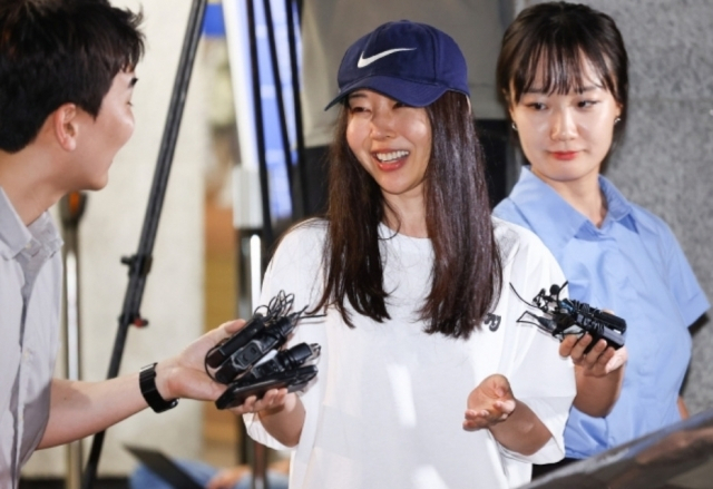 Former Ador CEO Min Hee-jin speaks to reporters while leaving Yongsan Police Station in Seoul on July 9, following questioning over her alleged breach of trust. (Newsis)